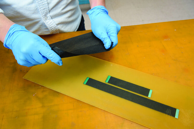 gloved hands touch a nanotube-based sensor material