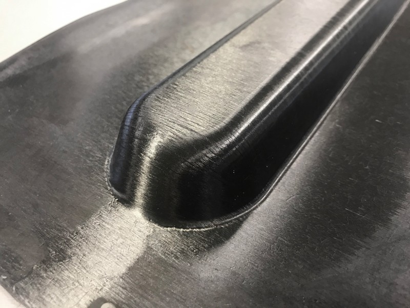 University of Delaware researchers have developed a new high-performance material, known as TuFF (Tailored Universal Feedstock for Forming), with properties equivalent to the best continuous fiber composites used in aerospace applications. Like sheet metal, TuFF can be stamped into complex shapes.