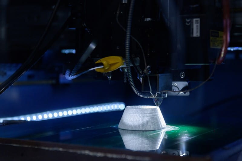 3D printer constructs a conical shape.