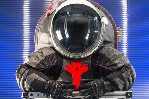 top half of an experimental EVA space suit with a large clear helmet.