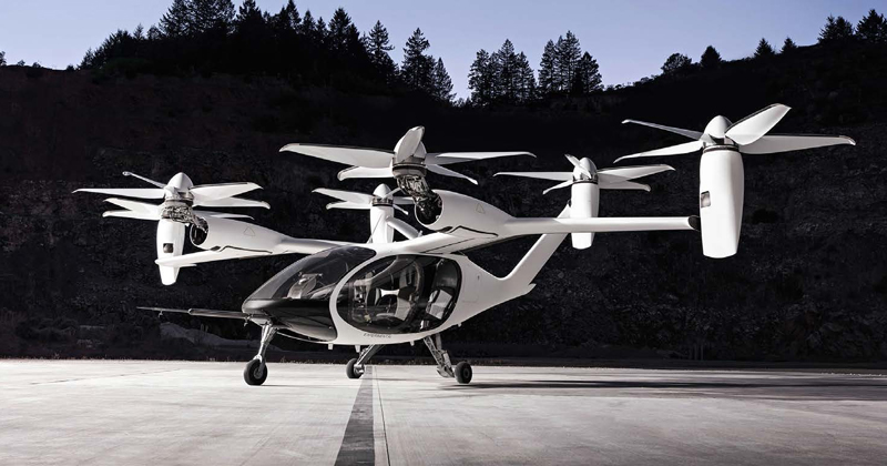 Prototype of a flying taxi with 4 vertical engines and a white body.