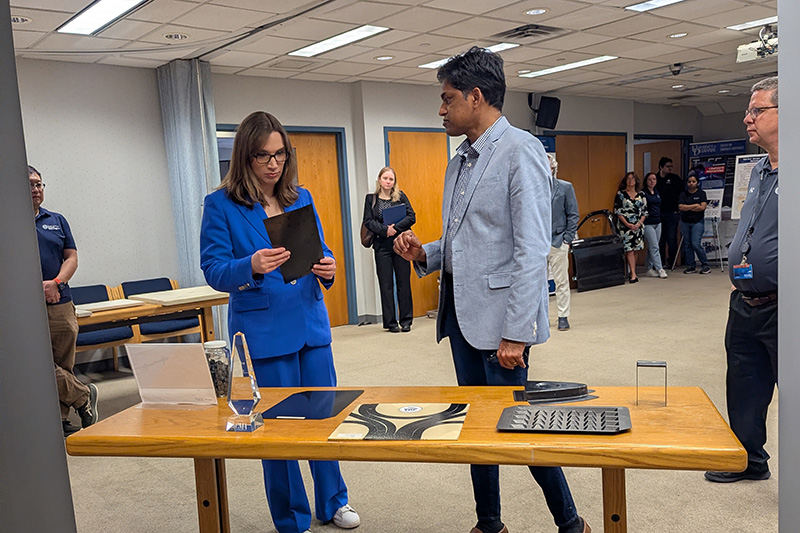 PXL_20260311_141315782.MP Rep. Sarah McBride in blue suit on left speaks with Shridhar Yarlagadda on right.