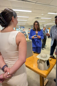 Rep. McBride speaks to a an undergraduate student about their research.